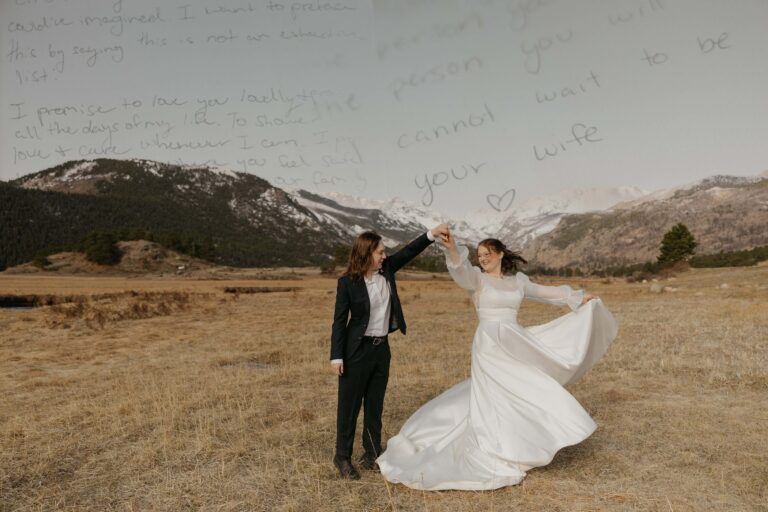 A suited partner twirls a partner in a flowing gown, layered with handwritten vows and mountain backdrop.