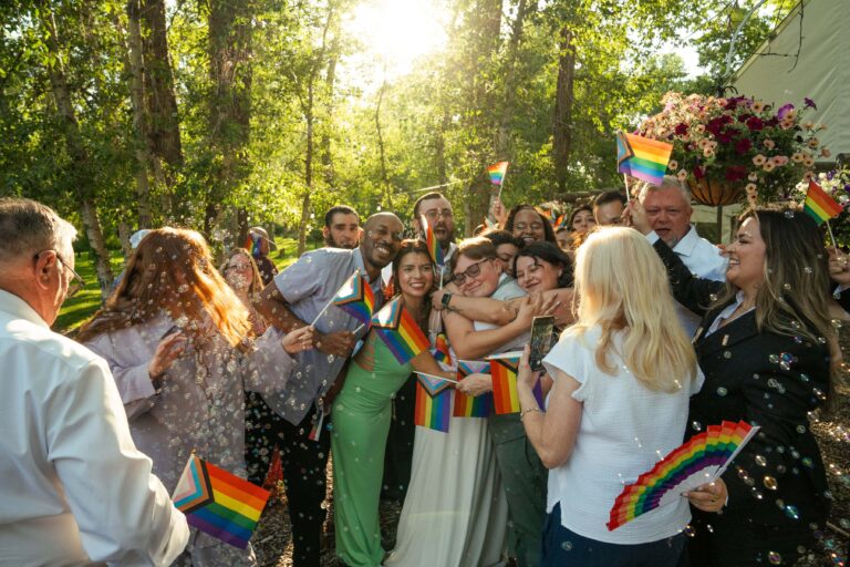 Group hug at outdoor queer wedding in Montana