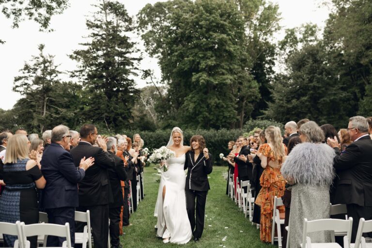 Brides walking up ceremony aisle together