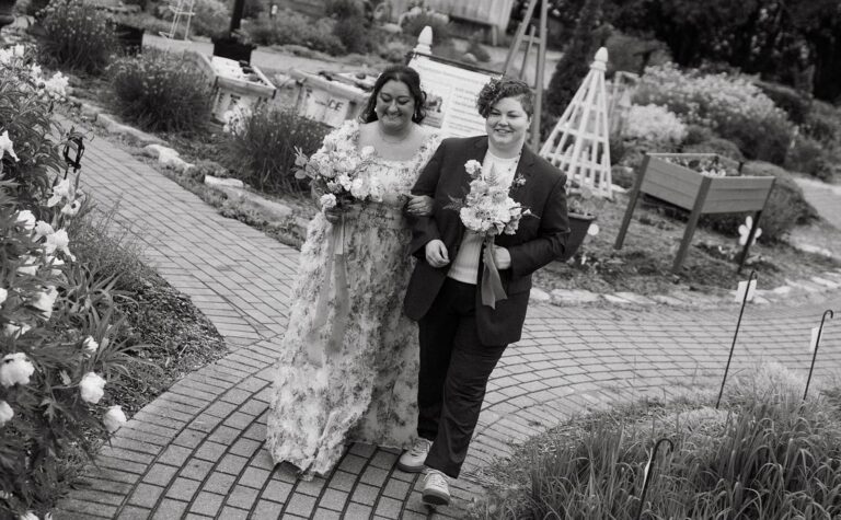 Walking together through garden path with bouquets
